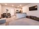 Open living space featuring a breakfast bar, stainless steel appliances, and an adjacent dining area at 7302 Sunray Point St, North Las Vegas, NV 89084