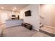 Open living space with a TV mounted on the wall and stairs visible in the background at 7302 Sunray Point St, North Las Vegas, NV 89084