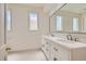 Clean, bright bathroom with dual sinks, white cabinets, and a large mirror at 8411 Carmel Ridge Ct, Las Vegas, NV 89113