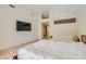 Bright bedroom features a king bed, mounted TV, and large windows for plenty of natural light at 8411 Carmel Ridge Ct, Las Vegas, NV 89113