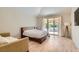 Cozy bedroom features a king-sized bed, neutral tones, and access to a private outdoor space at 8411 Carmel Ridge Ct, Las Vegas, NV 89113