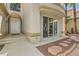 Home's entry with decorative tile, white front door, and smooth concrete walkway at 8411 Carmel Ridge Ct, Las Vegas, NV 89113