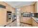 Well-equipped kitchen featuring wood cabinets, stainless appliances, and granite countertops at 8411 Carmel Ridge Ct, Las Vegas, NV 89113