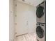 Convenient laundry room with stacked washer and dryer units and ample storage space at 8411 Carmel Ridge Ct, Las Vegas, NV 89113