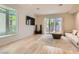 Spacious living room featuring wood floors, a large window, and ample natural light at 8411 Carmel Ridge Ct, Las Vegas, NV 89113