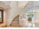 Open-concept living area with staircase offers seamless indoor-outdoor living with access to the pool at 8411 Carmel Ridge Ct, Las Vegas, NV 89113