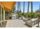 Outdoor kitchen and patio with a built-in grill, seating, and lush surroundings at 8411 Carmel Ridge Ct, Las Vegas, NV 89113