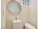 Stylish powder room with unique vessel sink, modern toilet, and glass block window detail at 8411 Carmel Ridge Ct, Las Vegas, NV 89113