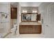 Beautiful bathroom with a walk in shower, dual sinks, and a large mirror at 8719 Villa Ariel Ln, Las Vegas, NV 89147