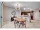 Dining area featuring a wooden table set with seating for four adjacent to the kitchen with bar stool seating at 8719 Villa Ariel Ln, Las Vegas, NV 89147