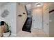 Inviting entryway featuring a staircase with dark wood steps and a landing, complemented by tile flooring at 8719 Villa Ariel Ln, Las Vegas, NV 89147