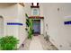 Inviting entryway with gravel landscaping and tropical plants for a serene welcome at 8719 Villa Ariel Ln, Las Vegas, NV 89147