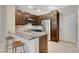 Well-lit kitchen with granite counters, stainless appliances, and bar seating at 8719 Villa Ariel Ln, Las Vegas, NV 89147