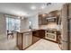 Stylish kitchen with stainless steel appliances, eat-in bar, and a view of the dining area at 8719 Villa Ariel Ln, Las Vegas, NV 89147