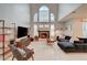 Bright living room with soaring ceilings, large windows, and modern furnishings at 8719 Villa Ariel Ln, Las Vegas, NV 89147