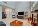 Spacious living room with a fireplace, high ceilings, and access to the staircase at 8719 Villa Ariel Ln, Las Vegas, NV 89147