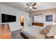 Spacious main bedroom featuring a king bed, dresser, tv, and ensuite bathroom entrance for optimal comfort at 8719 Villa Ariel Ln, Las Vegas, NV 89147
