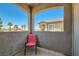 Balcony with red chair shows community homes and palm trees at 8805 Jeffreys St # 2073, Las Vegas, NV 89123