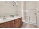 Bathroom features a glass enclosed shower, dual sinks, and tile floors at 8805 Jeffreys St # 2073, Las Vegas, NV 89123