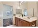 Bathroom features a double sink vanity with wood cabinets and tile floor at 8805 Jeffreys St # 2073, Las Vegas, NV 89123