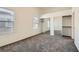 Bright bedroom with large windows and mirrored closet doors features neutral-toned carpet at 8805 Jeffreys St # 2073, Las Vegas, NV 89123