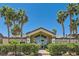 The beautiful community clubhouse offers a welcoming entrance, framed by lush landscaping and swaying palm trees at 8805 Jeffreys St # 2073, Las Vegas, NV 89123