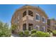 Exterior view of the building featuring a brown stucco facade, balcony, and well-maintained landscaping at 8805 Jeffreys St # 2073, Las Vegas, NV 89123