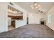 Cozy kitchen featuring wooden cabinets, white appliances, breakfast bar, and view of living room at 8805 Jeffreys St # 2073, Las Vegas, NV 89123