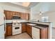 Traditional kitchen features stainless microwave, white appliances, and laminate countertops at 8805 Jeffreys St # 2073, Las Vegas, NV 89123