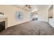 Spacious living room featuring fireplace, plush carpet, large window, and sliding glass door to patio at 8805 Jeffreys St # 2073, Las Vegas, NV 89123