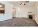 Bright living room featuring modern carpet, fireplace, and view of adjacent kitchen at 8805 Jeffreys St # 2073, Las Vegas, NV 89123