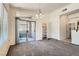 Living room featuring plush carpet, large window, sliding glass door to patio, and open access to kitchen at 8805 Jeffreys St # 2073, Las Vegas, NV 89123