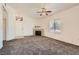 Spacious living room with fireplace, plush carpet, large window, and ceiling fan at 8805 Jeffreys St # 2073, Las Vegas, NV 89123