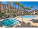 An inviting pool and spa combo, surrounded by swaying palms, offer a tranquil escape in the community at 8805 Jeffreys St # 2073, Las Vegas, NV 89123