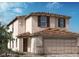 Charming two-story home featuring stucco siding, brown shutters, and a tile roof at 9649 Hinson St, Las Vegas, NV 89139