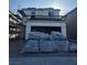Two-story home under construction featuring a garage and visible scaffolding at 9661 Hinson St, Las Vegas, NV 89139