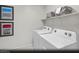 Bright laundry room featuring a white washer and dryer and decoratively framed artwork at 9687 Biedler Ct # Lot 2, Las Vegas, NV 89178