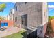 Exterior patio with brick pavers, stucco walls, a/c and grass at 9753 Villa Lorena Ave, Las Vegas, NV 89147