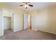 Bedroom with neutral carpet, a ceiling fan, and closet space at 9753 Villa Lorena Ave, Las Vegas, NV 89147