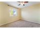 Bedroom featuring neutral carpet, a ceiling fan, and a window at 9753 Villa Lorena Ave, Las Vegas, NV 89147