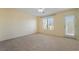 Bedroom features carpet, a ceiling fan, a window, and access to the balcony at 9753 Villa Lorena Ave, Las Vegas, NV 89147