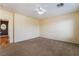 Bedroom featuring neutral carpet, a ceiling fan, and access to a hallway at 9753 Villa Lorena Ave, Las Vegas, NV 89147