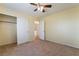Bedroom with neutral carpet, ceiling fan, and closet space at 9753 Villa Lorena Ave, Las Vegas, NV 89147