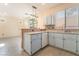 Bright kitchen featuring an island and stainless steel sink and faucet at 9753 Villa Lorena Ave, Las Vegas, NV 89147