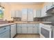 Bright kitchen with light blue cabinetry, stainless steel sink and appliances at 9753 Villa Lorena Ave, Las Vegas, NV 89147