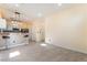 Open-concept living area flowing into kitchen, featuring a breakfast bar with modern light fixtures at 9753 Villa Lorena Ave, Las Vegas, NV 89147