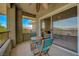 Relaxing balcony with seating, ceiling fan, and views from sliding glass door at 1001 Domnus Ln # 201, Las Vegas, NV 89144