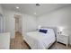 Bright bedroom with a queen bed, wood-style floors and white walls at 1001 Domnus Ln # 201, Las Vegas, NV 89144