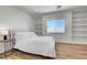 Comfortable bedroom featuring built-in shelving, wood-look floors, and bright natural light at 1001 Domnus Ln # 201, Las Vegas, NV 89144