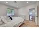 Bright bedroom with a queen bed, wood-style floors, a large window, and white walls at 1001 Domnus Ln # 201, Las Vegas, NV 89144